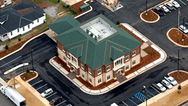 Projects: Aerial view of square bank building with slanted green roof