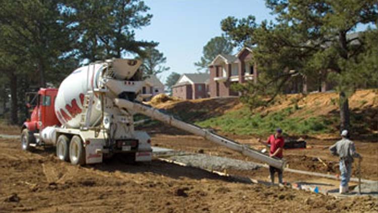 Projects: Concrete truck with two workers offloading concrete.
