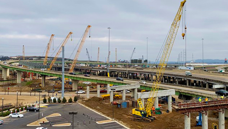 Projects: Multiple cranes at interstate highway construction site.